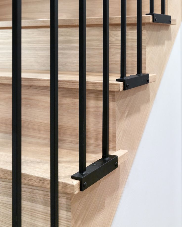 a wooden stair case with metal railings