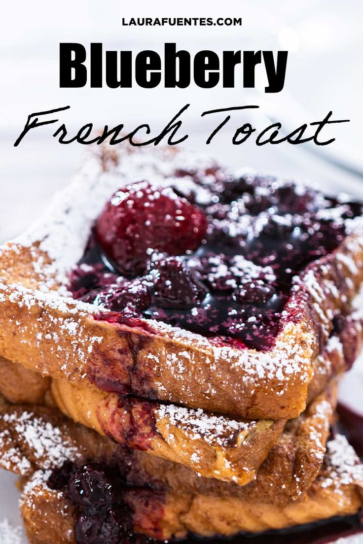 blueberry french toast on a plate with powdered sugar and berries in the middle