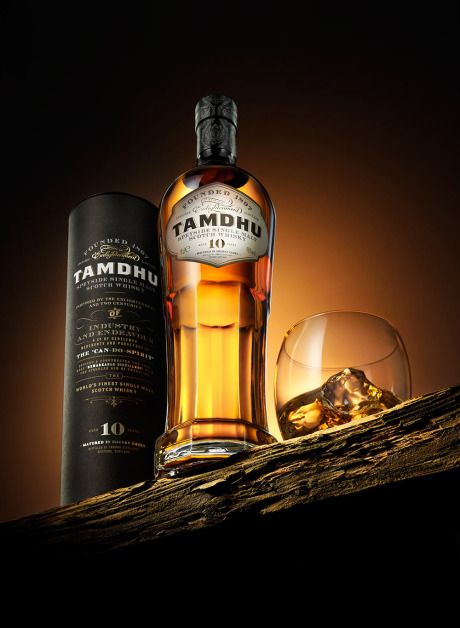 a bottle of tamdhu with a glass next to it