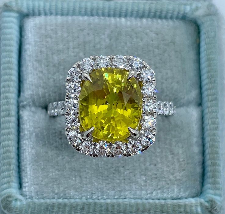 Stunning Yellow Sapphire and Diamond Ring White Gold.  This beautiful brilliant yellow sapphire is breathtaking to say the least; it is very sparkling and full of life.  This bright yellow color looks like a yellow diamond.  Sapphire is a hard gem, so it's durable for everyday wear.  The ring is excellent craftsmanship, all diamonds are set nice and smooth.  The diamonds are very sparkling.  This ring design is classy and a timeless design.  Hard to find a natural sapphire like this, not many in the market.  One Only ring! Genuine Earth Mined yellow sapphire gem 10 x 8.7mm and weighs 5.39 Carats  Excellent cut and Luster  May be heated/color enhanced Genuine earth mined Round Brilliant Cut Diamonds Total weight: 1.11 Carats  Clarity: SI Color: G All white and shiny diamonds, no cloudy or y Yellow Sapphire Engagement Ring, Yellow Sapphire Ring Engagement, Fancy Yellow Diamond Ring, Yellow Sapphire Ring, Sapphire Gem, Yellow Diamond Ring, Yellow Sapphire Rings, Yellow Diamond Rings, Yellow Rings