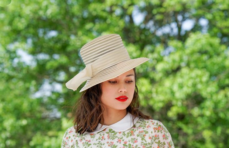 "DESCRIPTION * vintage hat from 1950s-1960s * Bucket hat design: tall flat crown, wide downturned brim * made of beige synthetic straw, swirled pattern of crinoline and polybraid capeline * the hatband is wrapped with thick velvet ribbon and formed two tails on the side * no tag CONDITION * hat is in good condition and shows signs of normal use but there are a few stains on the ribbon and a few natural yellowing spot on capeline braid which may look like some soiling but they are not. Please see Vintage Top Hat For Spring Wedding, Vintage Straw Hat For Spring Wedding, Classic Straw Hat For Spring Wedding, Retro Cream Hat With Curved Brim, Vintage Beige Top Hat With Curved Brim, Vintage Beige Top Hat With Short Brim, Vintage Summer Wedding Boater Hat, Classic Spring Church Hat, Vintage Spring Wedding Straw Hat