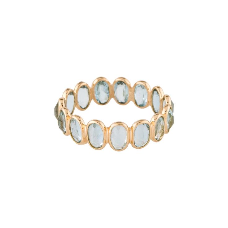 a gold ring with white stones on it