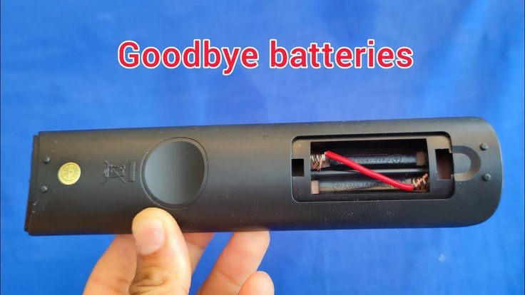 a hand holding an electronic device with the words goodbye batteries written on it in red