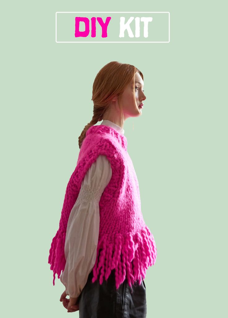 a woman wearing a pink knitted vest with fringes on the shoulders and sleeves