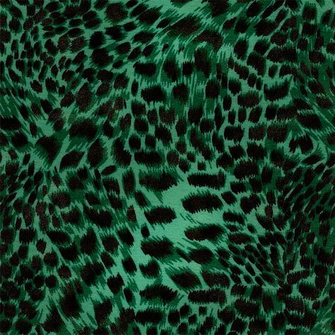 a green and black animal print fabric with lots of small spots on it's surface