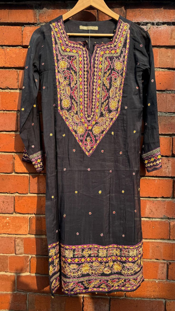 This is a one of a kind piece in size S only. Perfect for a mehendi/haldi/dholki, or a girl's night out. The delicate pink floral embroidery gives it a beautiful feminine look.  1Piece .  Dry clean only, with medium iron NO RETURNS. Semi-stitched Black Art Silk Blouse Piece, Black Silk Blouse Piece With Zari Work, Black Art Silk Blouse Piece For Eid, Black Art Silk Blouse Piece For Transitional Season, Black Silk Fabric With Zari Embroidery, Black Silk Embroidered Saree Fabric, Transitional Black Art Silk Blouse Piece, Black Semi-stitched Art Silk Blouse Piece, Bohemian Semi-stitched Raw Silk Traditional Wear