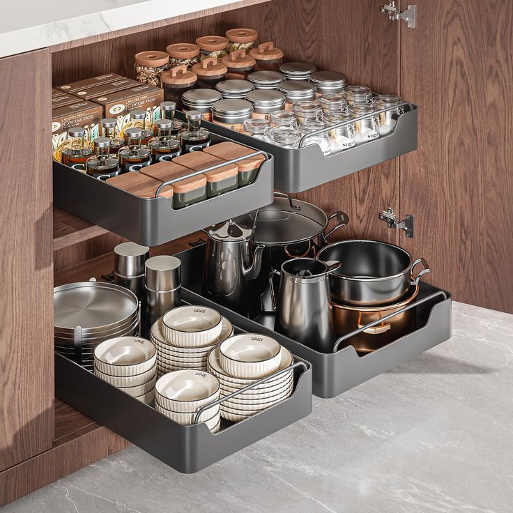 an organized kitchen drawer with pots and pans