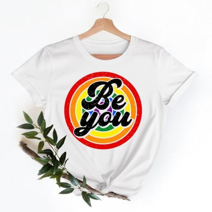 a t - shirt with the words be you on it next to a branch and leaves