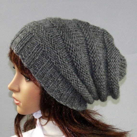 a mannequin head wearing a gray knitted hat