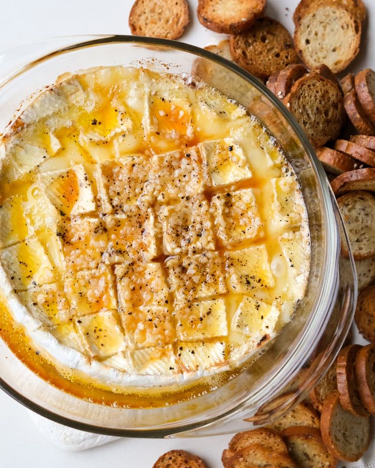 a glass bowl filled with cheese and crackers