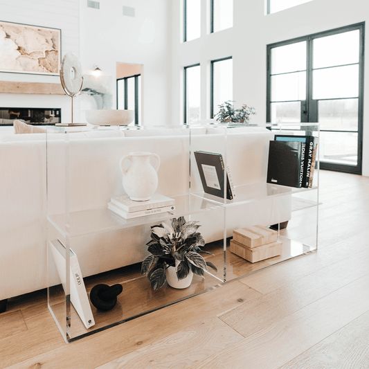 a living room filled with furniture and windows next to a wooden floor covered in hard wood