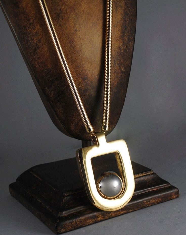 "ALL REASONABLE OFFERS CONSIDERED! This is a real relic of a bygone era! A true collector's piece! Very rare signed Lanvin Paris Pendant. This piece is from the 1970's. Never before worn. This Beautiful Vintage Lanvin Paris pendant is a jewelry piece you'll treasure forever! Jeanne Lanvin, the legendary designer, built a fashion empire in the 1920's. Her jewelry was considered modern to the French at that time and even today has the look of an Art Deco modern piece. This piece is in near mint co Gold-tone Metal Jewelry Collectible, Gold-tone Metal Jewelry For Collectors, Elegant Antique Gold Necklace For Collectors, Vintage Gold-tone Necklace For Anniversary, Vintage Metal Necklace With Polished Finish, Elegant Gold-tone Collectible Jewelry, Vintage Gold-tone Jewelry For Anniversary, Lanvin Vintage, Vintage Lanvin