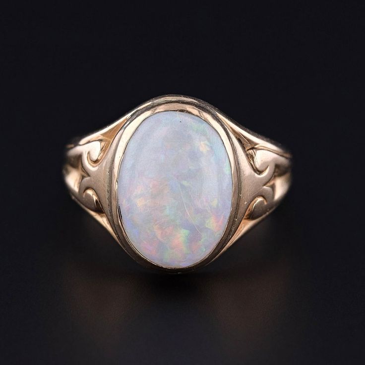 This antique ring (circa 1900) features a white opal set in 14k gold. The face of the ring measures 0.6 inches by 0.45 inches wide and is in good condition with some crazing to the opal.  The ring is a size 5.5, but it can be resized free of charge. We have many other fantastic offerings of period fine and costume jewelry posted on our Etsy store, so please consider browsing our other items. We send all items in individually packaged gift boxes. + Trademark Antiques Shop Homepage https://www.ets Classic Yellow Gold Opal Ring, Heirloom White Opal Ring Oval Cabochon, Heirloom Oval Opal Ring, Heirloom White Opal Ring, Classic Gold Opal Ring Collectible, Gold Opal Ring Collectible Classic Style, Vintage 14k Gold Opal Ring, Antique Yellow Gold Opal Ring Collectible, Classic Oval Opal Ring Collectible