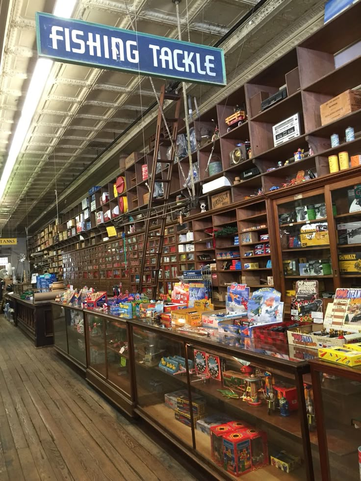 the inside of a fishing tackle store with shelves full of items and signs on them