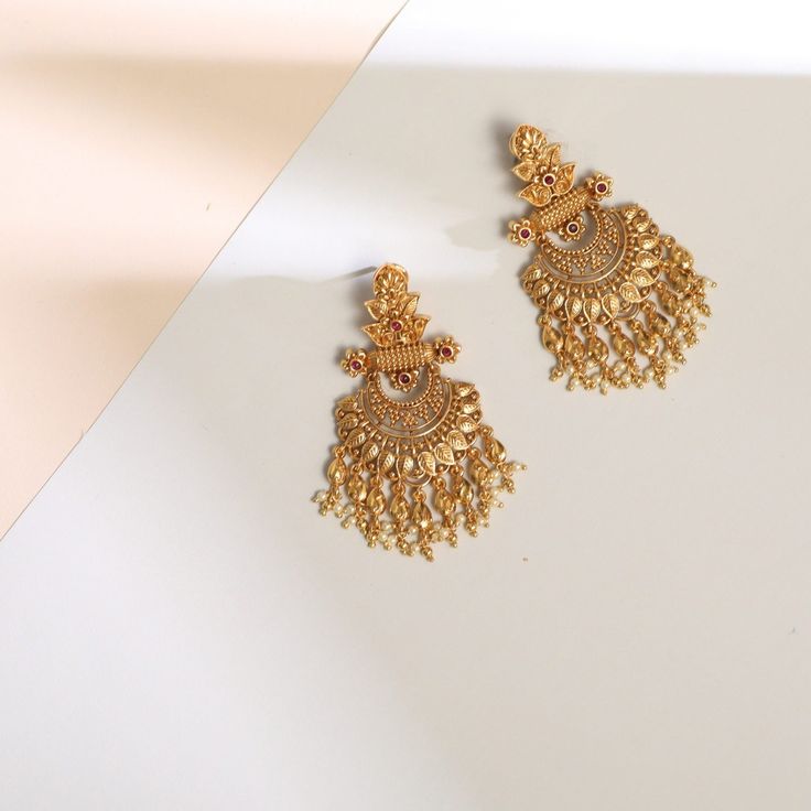 Description Inspired by the shimmering Indian gold jewelry. This Collection is designed to highlight fine Indian craftsmanship. It is crafted in gold-plated 925 silver with intricate textures and tones. Modern designs adorn you with timeless floral patterns. This jewelry is perfect for wedding and festival events. Glistening with festive elegance, these leafy floral silver chandbali earrings are a timeless piece made with traditional Indian design aesthetics. The design features a central floral Gold Tilla Danglers For Diwali, Gold Danglers With Tilla For Diwali, Gold Temple Jewelry Chandbalis With Latkans, Gold Chandbalis With Latkans In Temple Jewelry Style, Gold Brass Chandbalis For Diwali, Bollywood Style Gold Chandbalis In Brass, Brass Jhumkas With Intricate Design For Wedding, Wedding Temple Jewelry Style Brass Chandbalis, Festive Bridal Chandbali Earrings With Elegant Design