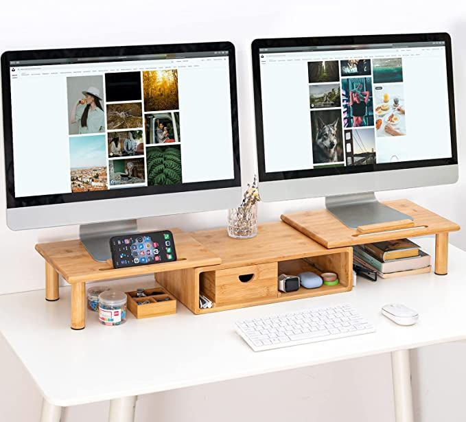 two computer monitors sitting on top of a white desk next to each other with pictures on them