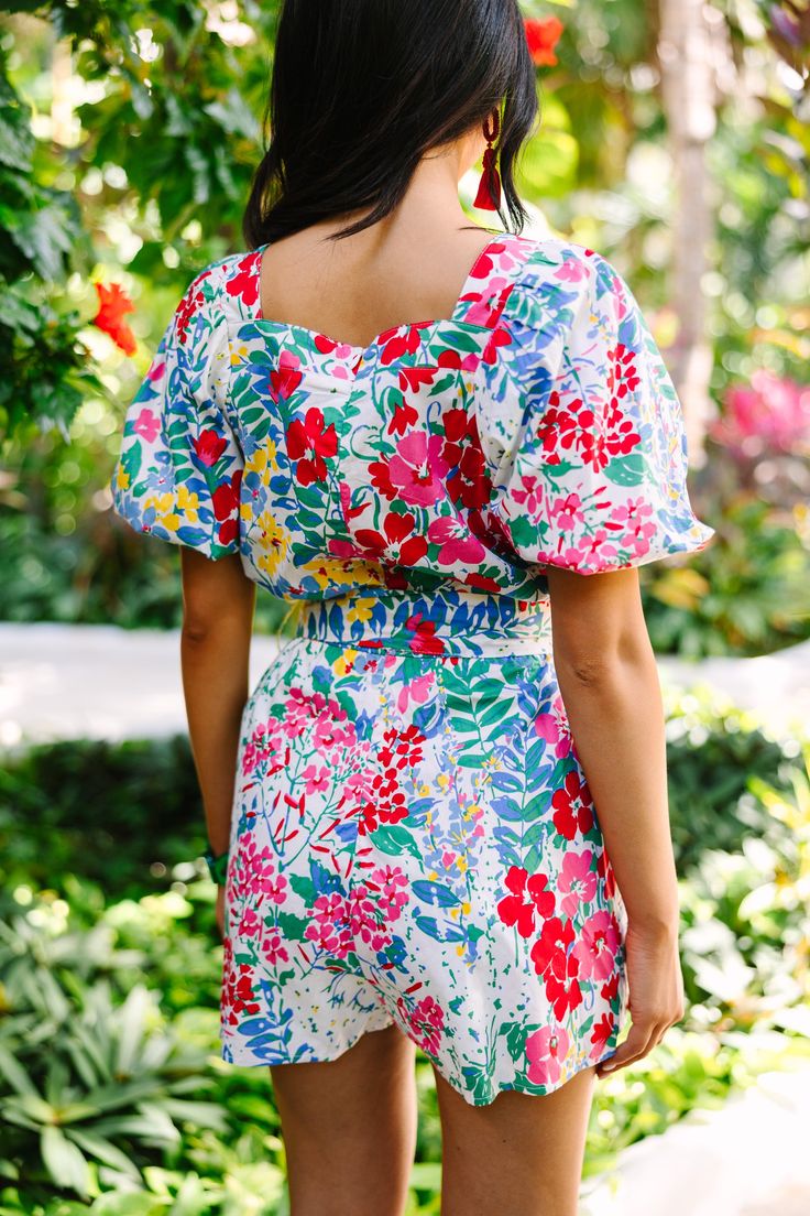 Stand out in this Can't Say No White Floral Romper! This irresistible piece flaunts a bold floral print and irresistible puff sleeves. With a figure-flattering fit, it's perfect for those days when you want to look cute but keep it playful. Simply pair with sneakers or sandals and you're ready to go! This romper features a smocked back, short puff sleeves, a square neckline, a back zip closure, a tied waist, and a colorful floral print. Material has no amount of stretch.Cindy is wearing the smal Vacation Floral Print Top With Square Neck, Vacation Tops With Floral Print And Square Neck, Floral Print Vacation Tops With Square Neck, Floral Print Square Neck Top For Vacation, Spring Multicolor Square Neck Tops, Multicolor Square Neck Tops For Spring, Square Neck Floral Print Tops For Day Out, Feminine Multicolor Top For Garden Party, Multicolor Fitted Tops With Ditsy Floral Print