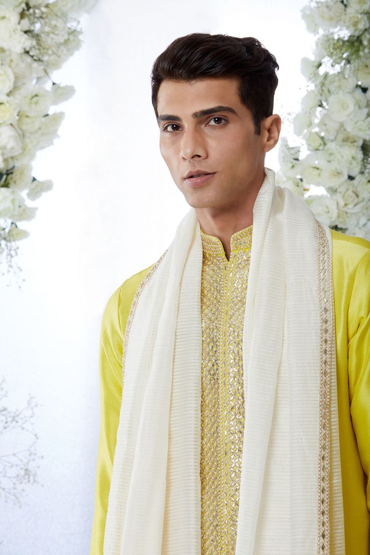 This corn yellow kurta set features all over gota patti embroidery on a silk base. It is paired with an embroidered off-white salwar. Completing embroidered stole is also available.From Seema Gujral's Tuscan Summer collection. DELIVERY TIMEPlease allow 8-12 weeks for your outfit to arrive.FABRIC DETAILSTissue Raw SilkProfessional cleaning only. Festive White Unstitched Suit With Dori Work, White Bollywood Unstitched Suit With Dori Work, White Unstitched Suit With Dori Work For Festive Occasions, Bollywood Style White Unstitched Suit With Dori Work, Diwali White Unstitched Suit With Dori Work, White Chanderi Churidar With Dori Work, White Dola Silk Unstitched Suit With Traditional Drape, White Unstitched Suit With Dori Work For Festivals, Off White Dupatta For Designer Wear And Eid