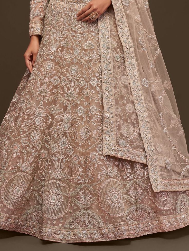 Craving to steal the show with an ethnic look by wearing this gorgeous beige soft net lehenga embellished with thread, and dori embroidery, and highlighted with glitter zari, and beautiful badla.
This gorgeous beige soft net lehenga comes with a similar color soft net blouse embellished with the same design as the lehenga and comes with a beautiful similar color dazzling dupatta embellished with thread, dori embroidery through zari, and beautified with glitter badla.
This stunning beige lehenga Beige Semi-stitched Gown For Reception, Beige Floor-length Sets With Intricate Embroidery, Beige Anarkali Gown With Sheer Dupatta, Beige Gown With Zari Work, Fitted Bollywood Style Beige Lehenga, Fitted Beige Lehenga With Dupatta, Beige Fitted Lehenga With Dupatta, Beige Anarkali Sharara For Party, Fitted Beige Bollywood Lehenga