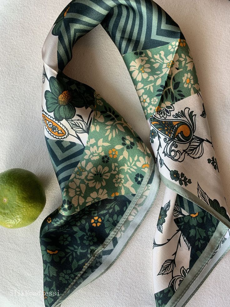 Versatile green floral natural mulberry silk small square scarf with size of 53 cm x 53 cm / 20.8 in x 20.8 in. Art-deco prints, with a lavish array of patterns ranging from ornate paisleys to simple stripes. Bold, and carefree, yet complemented by the sophisticated shades of green and white, embellished with a bright orange. Soft, smooth, and lustrous silk charmeuse, soft warm colors, one sided quality print, fabric breathable and skin-friendly feels very comfortable to wear. Can style in different ways: wear this scarf as a small neck scarf, as a hair tie scarf, as a headband, as a bag accessory, as a wrist band...or style it any way you want with your own sense of creativity! Suitable for all seasons and is a lovely gift idea for special occasions. Care Instructions: Pure silk is a type Luxury Chic Green Silk Scarf, Luxury Green Traditional Silk Scarf, Elegant Green Scarves For Spring, Trendy Green Silk Scarf For Spring, Elegant Green Scarves For Summer, Chic Green Silk Scarf For Spring, Elegant Green Summer Scarves, Green Bohemian Silk Scarf With Floral Print, Chic Green Summer Scarves