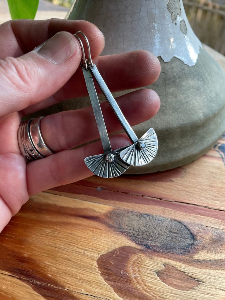 "Hand made by me in my seattle studio 🙂 sterling silver is shaped into half moon \"fans\" and hand engraved. A sparkly cz is tube-set to add interest.  They hang 2-inches from sterling silver lever-backs." 2nd Earrings, Tube Setting, Metalsmith Jewelry, Metal Jewelry Making, Stick Earrings, Metalsmithing Jewelry, Silver Jewelry Design, Jewelry Metal, Jewellery Earrings