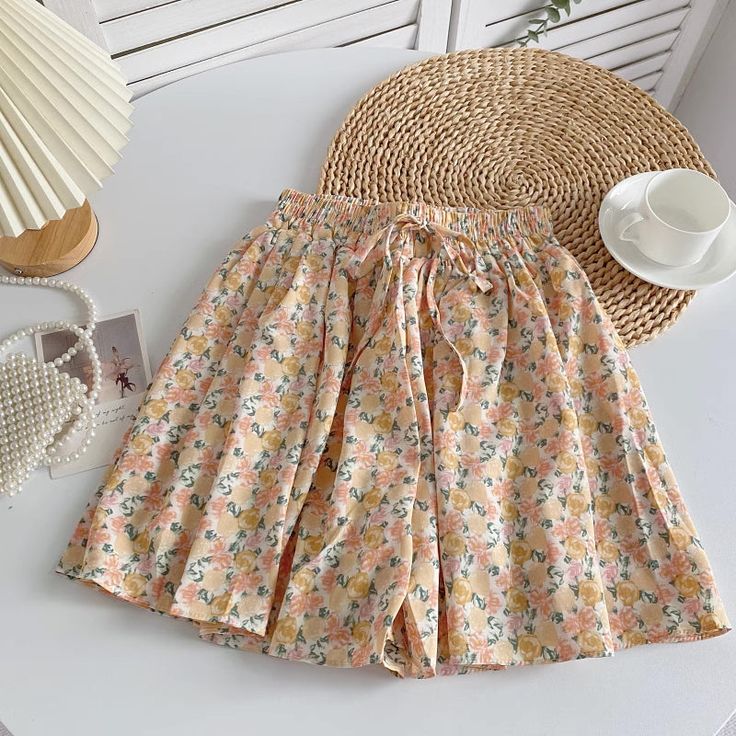 Easy breezy flowy chiffon printed skorts with an elasticized waist and ties. You'll be reaching for these when the warm summer days hit., One Size: 23"-43" waist, 60" hips, 15.5" length Shoe Gifts, Easy Breezy, Floral Shorts, Summer Floral, Overall Dress, Skorts, Sweater Blouse, Yellow Roses, Cardigan Jacket