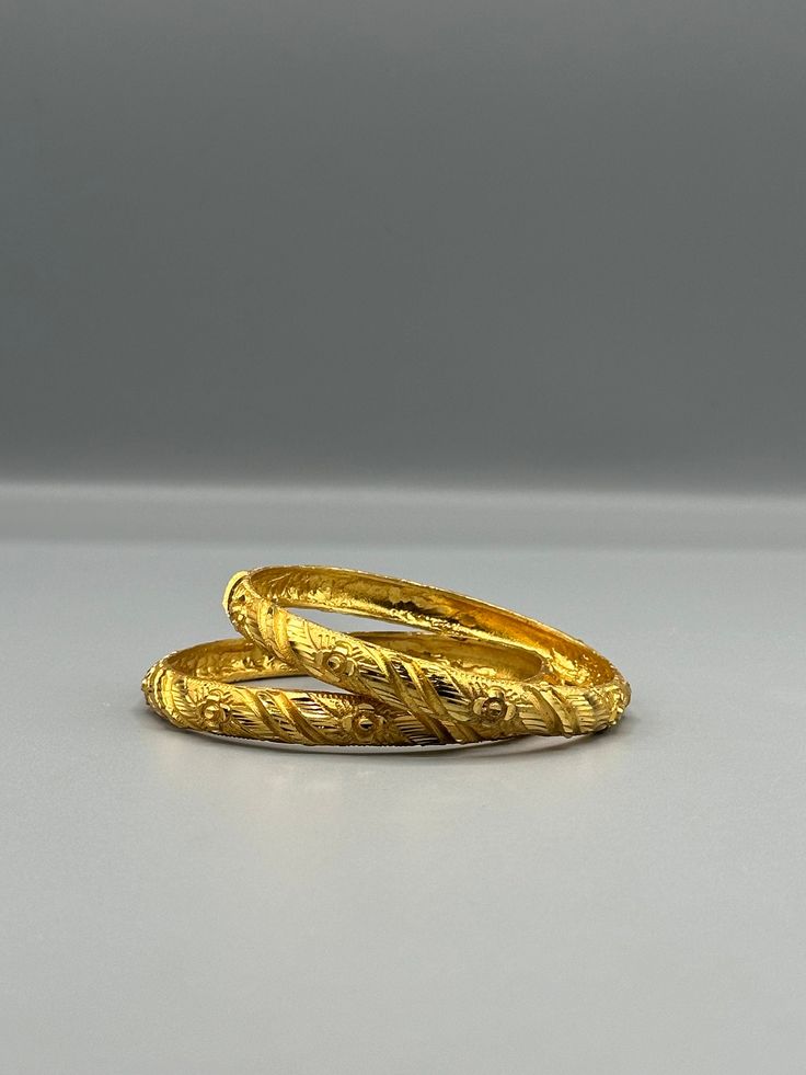 Our 24k Polished Bangles are more than just accessories; they are symbols of grace and beauty, inspired by the rich heritage of Indian, Pakistani, and Nepali jewelry. These stunning bangles showcase the timeless elegance of traditional craftsmanship, perfectly complementing your attire for weddings, festivals, or any special occasion Our company offers expedited Next-Day Delivery Services within the United Kingdom, ensuring prompt and efficient transportation of goods.  Additionally, we strive to extend our shipping capabilities to cater to customers worldwide, aiming to provide the fastest possible shipping methods to international destinations. To ensure the highest standards of hygiene, we kindly request your understanding that all sales are final, and we are unable to accept returns or Festive Yellow Hallmarked Jewelry, Yellow Temple Jewelry With Intricate Design, Traditional Yellow Hallmarked Jewelry, Traditional Yellow Gold Bracelet For Wedding, Yellow Jewelry For Anniversary And Festivals, Traditional Ceremonial Bangle With Filigree, Festive 22k Gold Round Bracelet, Classic Wedding Bangle Hallmarked, Handmade Yellow Gold Festive Jewelry