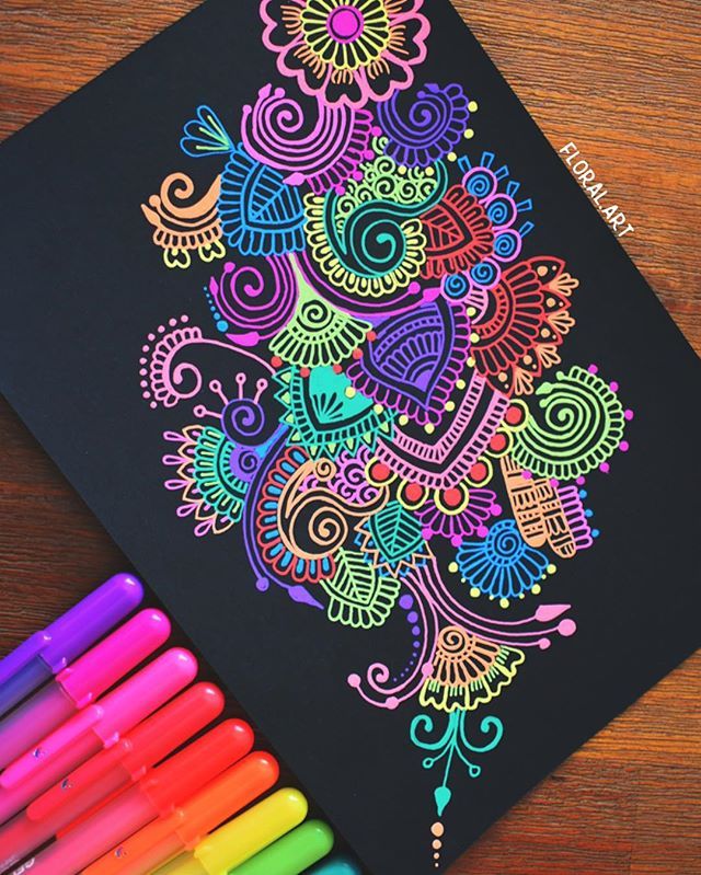 an image of a coloring book with markers on the table next to it and some pens