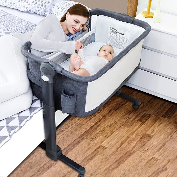 a woman is laying in her crib and looking at the baby's book