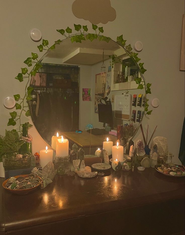 a table topped with plates and candles next to a mirror