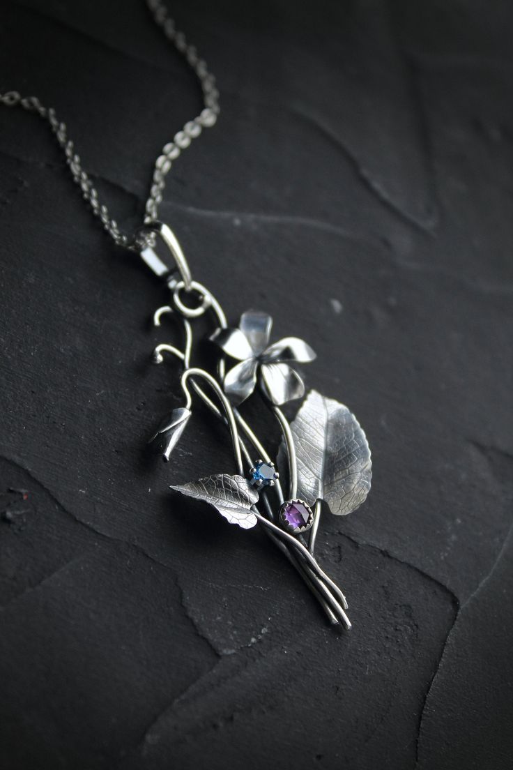 ITEM DESCRIPTION: The size H 5 cm x W 3 cm (2 x 1 1/3 inch). Weight - 3 g. You can buy it with a silver chain or without it. This spring flower is so delicate. So I was inspired by nature and made a wild violet flower of sterling silver, amethyst, and blue zircon. This is a very detailed handmade necklace. This floral jewelry will be a great addition to your jewelry collection or gift for someone whose you love. This handmade necklace will come to you in a gift box - ready for gifting. The parce Unique Flower Pendant Necklaces With Charm, Silver Nature-inspired Necklace With Flower Charm, Silver Necklace With Nature-inspired Flower Charm, Nature-inspired Flower Charm Pendant Necklace, Nature-inspired Silver Flower Necklace With Charm, Nature-inspired Sterling Silver Flower Jewelry, Nature-inspired Flower Shaped Sterling Silver Jewelry, Sterling Silver Birth Flower Pendant Necklace, Botanical Silver Jewelry With Birth Flower