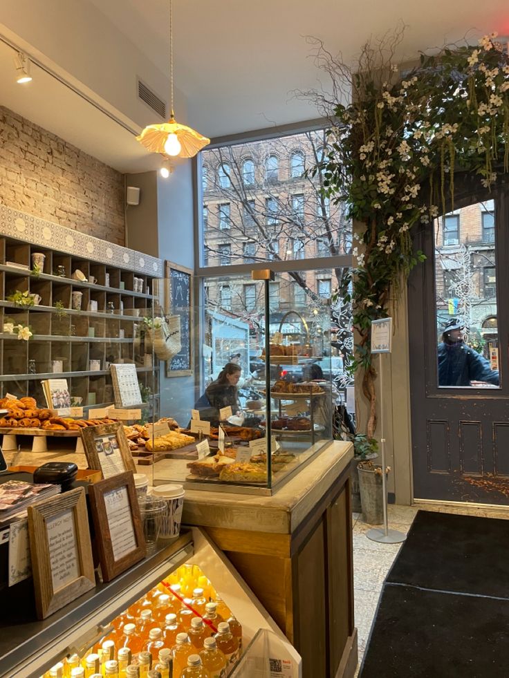 the inside of a bakery with lots of food on display