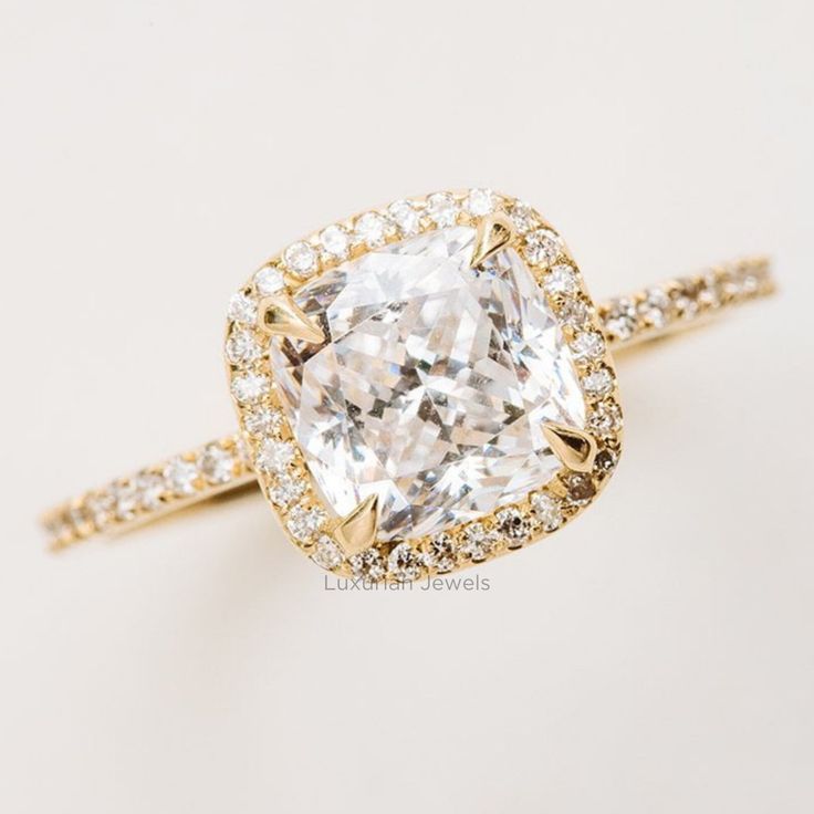 an engagement ring with a cushion cut diamond in the center