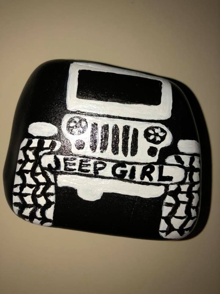 a black and white rock with a jeep on it