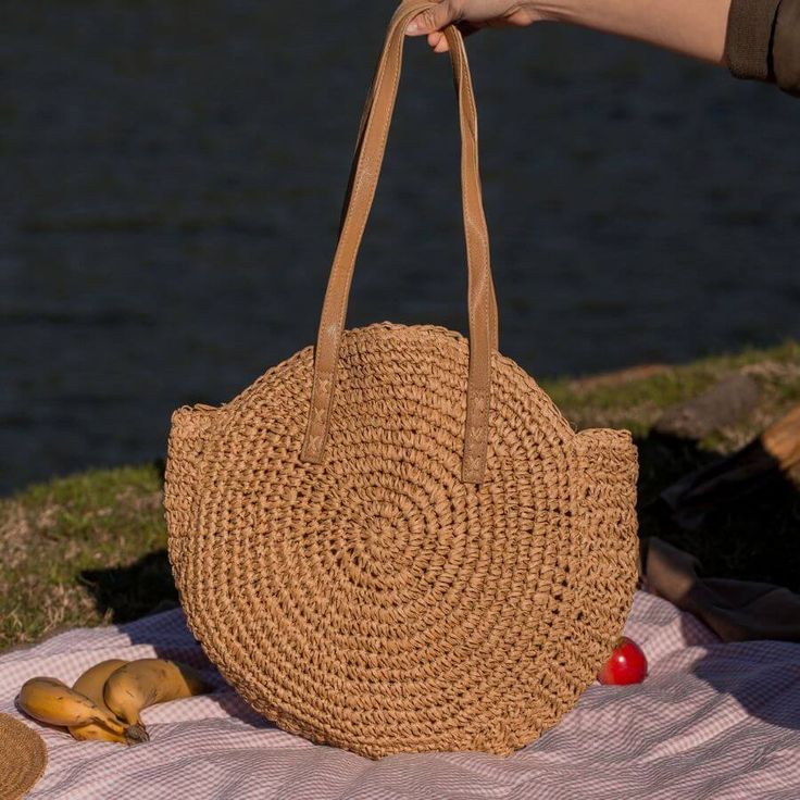 Introducing our Round Straw Bag - the epitome of summer chic and beach vibes. This rattan beach tote bag, also known as the Bali Bag, is the perfect accessory to elevate your style and bring a touch of bohemian charm to any outfit. Shape and Style: The bag's round shape adds a unique and trendy element to your look, making it a standout piece wherever you go. Its boho-inspired design is perfect for beach days, vacations, or casual outings, giving you that relaxed and carefree feel. Versatile Sho Chic Lightweight Straw Bag For Vacation, Chic Straw Bag For Everyday Vacation Use, Chic Straw Bag For Vacation And Everyday Use, Chic Beach Bag Made Of Natural Fiber, Bohemian Beach Bag In Natural Fiber For Vacation, Chic Straw Bag For Daily Use And Vacation, Chic Straw Bag For Daily Use On Vacation, Bohemian Natural Fiber Beach Bag For Vacation, Large Capacity Basket Beach Bag For Summer