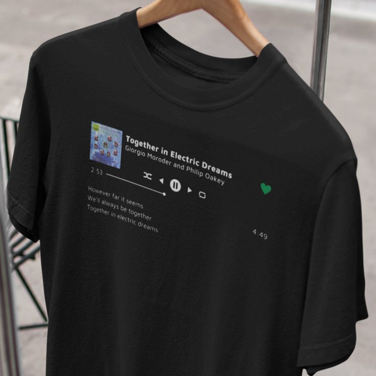 a black t - shirt with the words together in electric dreams on it hanging from a clothes rack