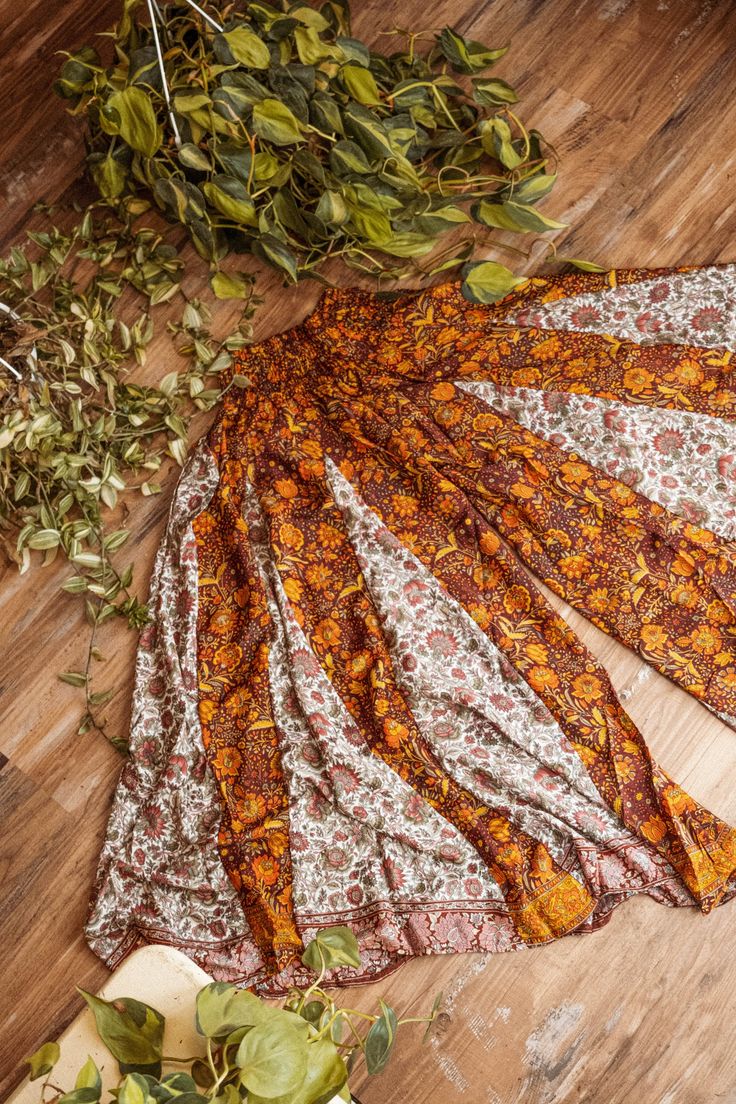 "Gorgeous patch flowy flare pants with a wide stretchy comfort elastic waistband. Available in 3 color blends Rust, Airy and Woodland. Rust is a blend of our Jewel Field and Burgundy Light prints Airy is a blend of our Lyla's Garden and Butter Flower prints. Woodland is a blend of our Goldie's Garden and Midnight Forest prints.   Regular stretches 26 - 46\" waist Plus stretches from 40 - 60\" waist Length - 38\"" Bohemian Bottoms With Elastic Waistband For Fall, Bohemian Style Bottoms With Elastic Waistband For Fall, Bohemian Stretch Harem Pants With Elastic Waistband, Multicolor Stretch Long Skirt, Flowy Festival Bottoms With Elastic Waistband, Bohemian Flowy Wide Leg Pants With Elastic Waistband, Bohemian Stretch Wide Leg Pants For Fall, Flowy Bohemian Pants With Elastic Waistband, Flowy Bottoms With Elastic Waistband For Festivals