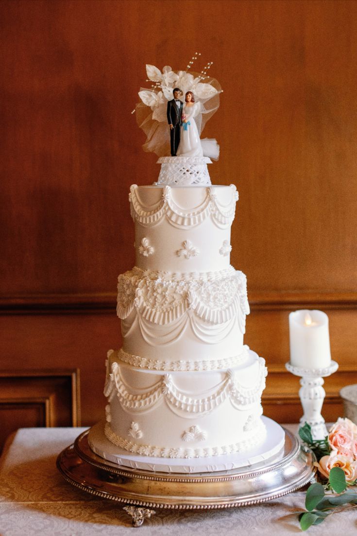 A three-tiered wedding cake with delicate lace design including a vintage cake topper of a bride and groom. | Photo by Sarah Block Photography Delicate Wedding Cake, Three Layer Cake Wedding, Vintage Wedding Cake With Topper, Traditional Wedding Cake Topper, Wedding Cake Designs Vintage, Retro Wedding Cakes Vintage, Vintage Piped Wedding Cake, Vintage Cake Toppers Wedding, Wedding Cake Retro