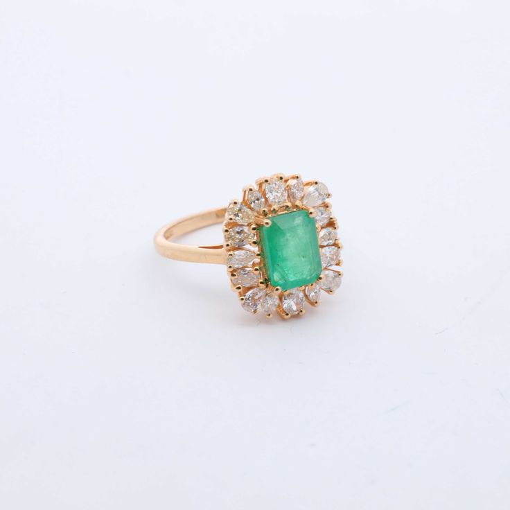 Indulge in luxury with our exquisite Emerald and Diamond Cocktail Ring. Adorned with stunning emeralds and diamonds, this ring exudes sophistication and elegance. Elevate any outfit with this timeless piece, perfect for any occasion. Feel like a true icon when you wear our Emerald & Diamond Cocktail Ring. 14k Yellow Gold 1.75CTW Natural Emerald Natural Diamonds: .80CTW Round Diamonds Luxury Emerald Cluster Ring With Center Stone, Luxury Emerald Cut Emerald Cluster Ring, Luxury Green Cluster Ring With Center Stone, Elegant Green Emerald Ring With Halo Setting, Elegant 14k Gold Emerald Ring For Formal Occasions, Timeless Emerald Diamond Wedding Ring, Luxury Emerald Cluster Ring With Halo Setting, Luxury Cluster Emerald Ring With Halo Setting, Luxury Emerald Rings With Rose Cut Diamonds