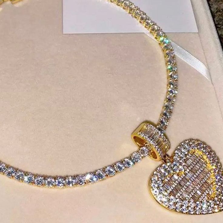 This Item Comes With A 16 Inch Tennis Chain Choker And Heart Pendant. You Can Choose Which Length You Want Gold Crystal Rhinestone Necklace For Valentine's Day, Valentine's Day Gold Crystal Rhinestone Necklace, Heart Charm Crystal Jewelry, Crystal Heart Jewelry With Heart Charm, Cubic Zirconia Heart Pendant Jewelry With Heart Beads, Gift Heart-shaped Cubic Zirconia Rhinestone Necklace, Heart-shaped Cubic Zirconia Rhinestone Necklace As Gift, Valentine's Day Heart Pendant Jewelry With Bling, Bling Cubic Zirconia Necklaces For Valentine's Day