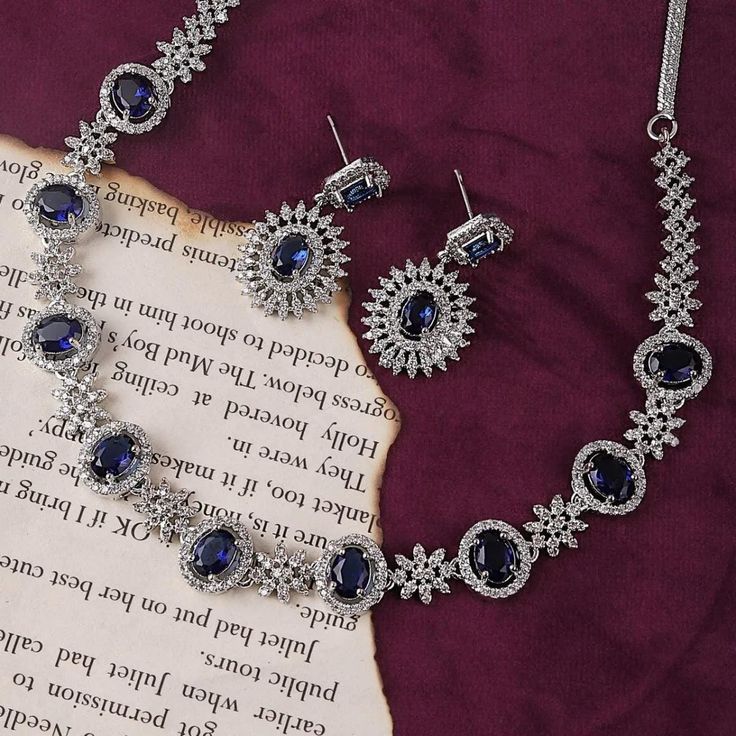 Exude elegance and sophistication with this Blue Ryan Necklace & Earring Set. Featuring sparkling royal blue stones set in a luxurious silver-toned finish, this set is perfect for adding a touch of class to any special occasion. Features: *Dazzling Blue Stones with Zircon Accents: Each piece is adorned with deep blue stones framed by a halo of shimmering zircons, creating a striking and elegant appearance. *Graceful Design for Any Occasion: Whether attending a formal event or adding sparkle to a Zircon Necklace, Blue Stones, Blue Ray, Evening Outfits, Wedding Jewelry Sets, Necklace Sizes, Necklace Earring Set, Stone Settings, Blue Stone