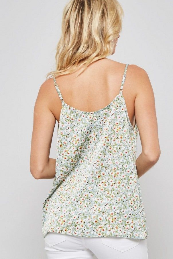 A floral pattern woven camisole blouse featuring cowl neckline, adjustable cami straps, sleeveless, and low back design 100% Polyester Chic Floral Print V-neck Tank Top, Spring Beach Tops With Delicate Straps, Spring Vacation Camisole With Delicate Straps, Summer Vacation Tops With Ditsy Floral Print, Ditsy Floral Print Tops For Vacation In Summer, Summer Floral Print Camisole With Tank Straps, Floral Print Summer Camisole With Tank Straps, Floral Print Camisole With Tank Straps For Summer, Spring Floral Print Sleeveless Camisole