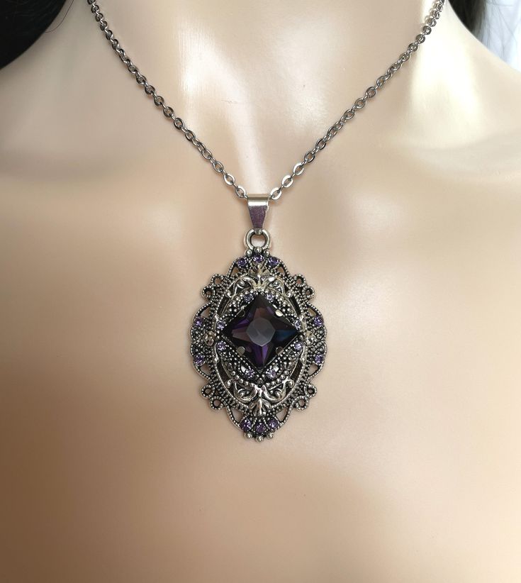 "This richly detailed antiqued silver plated filigree pendant, is adorned with dazzling VIOLET PURPLE glass rhinestones that perfectly accentuate a larger jewel in the center. Pendant measures 2 1/4\" tall (including the bail) and 1 1/4\" wide. It is worn on a cable chain in your choice of length and fastens with a lobster clasp. Listing is for necklace ONLY. Matching earrings are listed in our store. This is available in a variety of stone colors in our store, along with matching earrings. If y Ornate Silver Necklaces For Vintage Events, Metal Filigree Jewelry For Vintage Style, Metal Filigree Jewelry For Vintage Collection, Antique Silver Necklace With Intricate Design For Formal Occasions, Formal Antique Silver Necklace With Intricate Design, Victorian Style Nickel-free Necklace For Weddings, Antique Filigree Silver Jewelry, Victorian Wedding Necklace Nickel-free, Art Deco Silver Necklace With Filigree