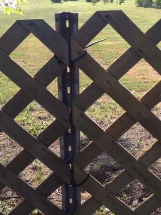 a wooden fence in the middle of a field