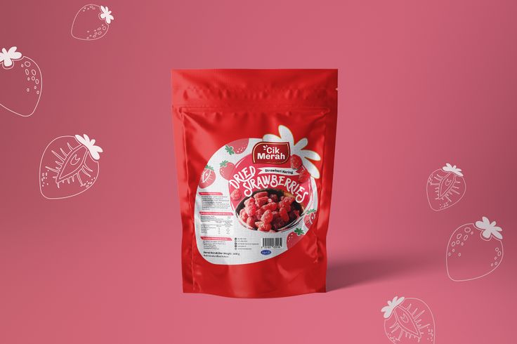 a bag of frozen strawberries on a pink background