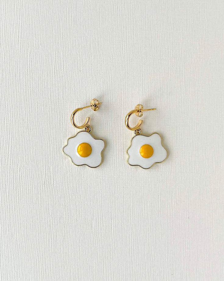 Description Sunny Side Up Earrings Details  * Length: 1.50 Inches; Width: 0.75 Inch (approx.)  * Materials: Enameled charms and stainless steel hooks   * Location: Earlobe  * Closure: Push back  * Style: Boho & hippie This is a limited edition handmade by Soane from our studio in Calgary. Trendy Gold Enamel Earrings, Trendy Nickel-free Enamel Earrings, Trendy Enamel Nickel-free Earrings, Enamel Dangle Single Earring, Trendy Hypoallergenic Enamel Earrings, Pierced Dangle Earrings In Enamel, Single Enamel Drop Earring, Trendy Enamel Earrings For Everyday, Everyday Gold Enamel Earrings