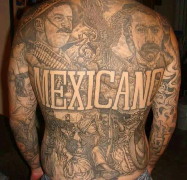 the back of a man with tattoos on his body and mexican writing written in large letters