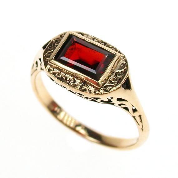 9CT/9K SOLID GOLD NATURAL GARNET SCROLL RINGThis lovely Vintage inspired ring has been crafted in 9ct Solid Yellow GoldAn Earth Mined NATURAL GARNET has been masterfully inset into a bezel as the centrepiece and has been beautifully decorated on the face with scroll patterns. A pierced gallery is another highlight of this ring and runs subtly along the shoulders creating an elegant looking vintage inspired piece ready to be cherished and enjoyed by the lady who appreciates wearing fine jewellery Elegant Garnet Ruby Ring Stamped 14k, Gold Garnet Birthstone Ring, Antique Red 14k Gold Signet Ring, Antique Red Signet Ring In 14k Gold, Antique 14k Yellow Gold Emerald Ring, Antique Emerald Ring In 14k Yellow Gold, Antique 14k Gold Signet Ring With Gemstone, Garnet Rings Stamped 14k For Anniversary, Anniversary Garnet Rings Stamped 14k