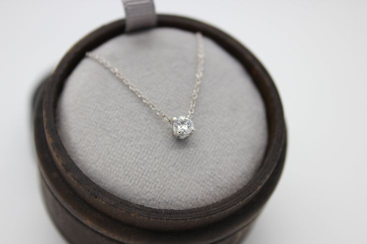 "This classic necklace features a round floating diamond basket set. Beautiful solitaire diamond necklace, perfect for a sparkly everyday look. *4 mm= .25 carats approximately. *4.4 mm= .33 carats approximately. *4.8 mm= .40 carats approximately. * Handmade in the USA. * Gold KT: 14K/18K gold. * Diamonds: Round Diamond * Color and Clarity: H (or better) / SI2 (or better). * Chain type: 1 mm cable chain, Lobster clasp. * Chain length: 15\"-16\", 17\"-18\". * Setting Type: Basket Setting. * Made t Fine Jewelry Solitaire Necklace With Brilliant Cut For Everyday, Timeless Everyday Solitaire Necklace With Prong Setting, Silver Prong Set Diamond Necklace For Everyday, Sterling Silver Solitaire Necklace With Prong Setting For Everyday, Everyday Fine Jewelry Solitaire Necklace With Brilliant Cut, Everyday Sterling Silver Solitaire Necklace With Prong Setting, Timeless Solitaire Necklace For Everyday, Sterling Silver Solitaire Necklace For Everyday, Timeless Everyday Solitaire Necklace