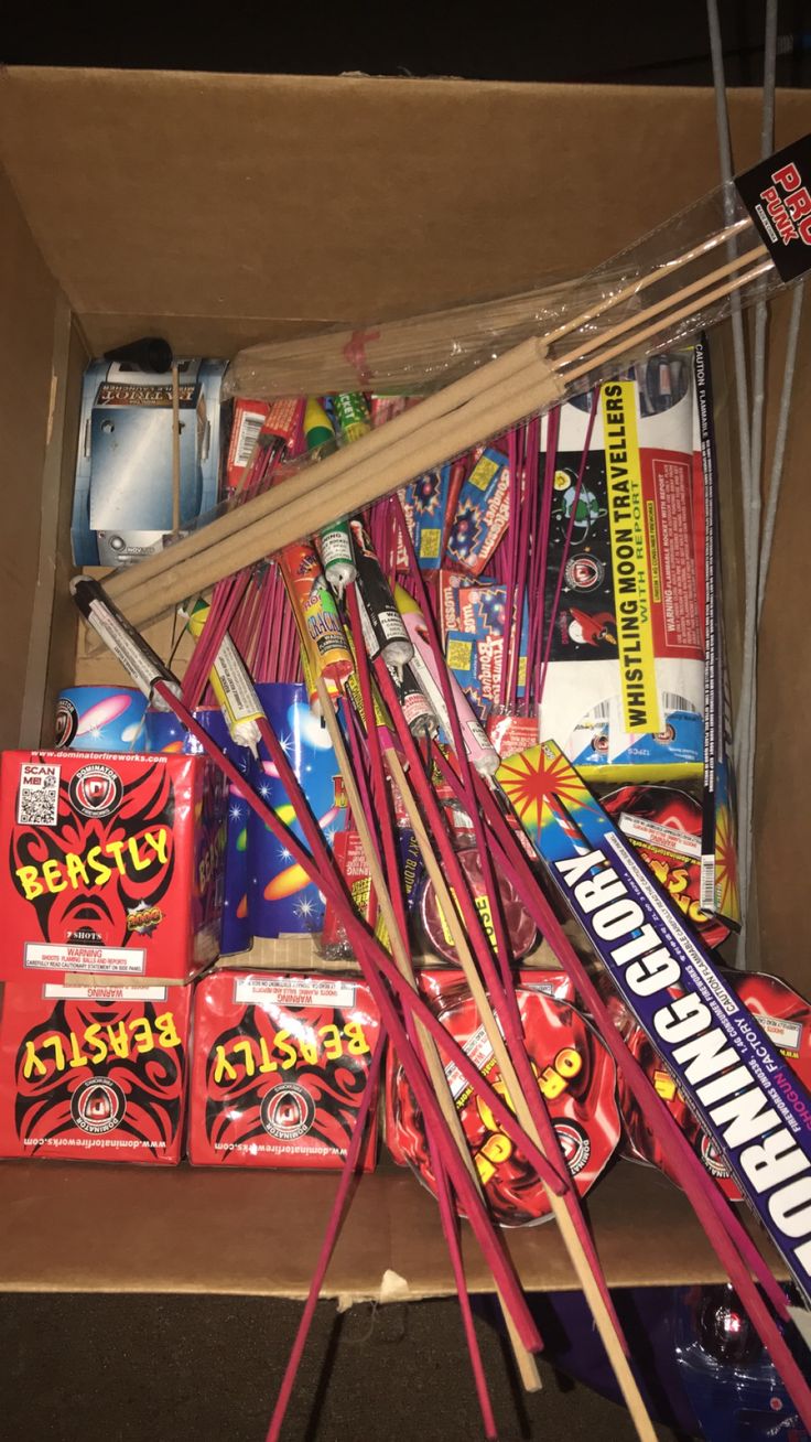 a box filled with lots of different types of candy and toothbrushes next to each other